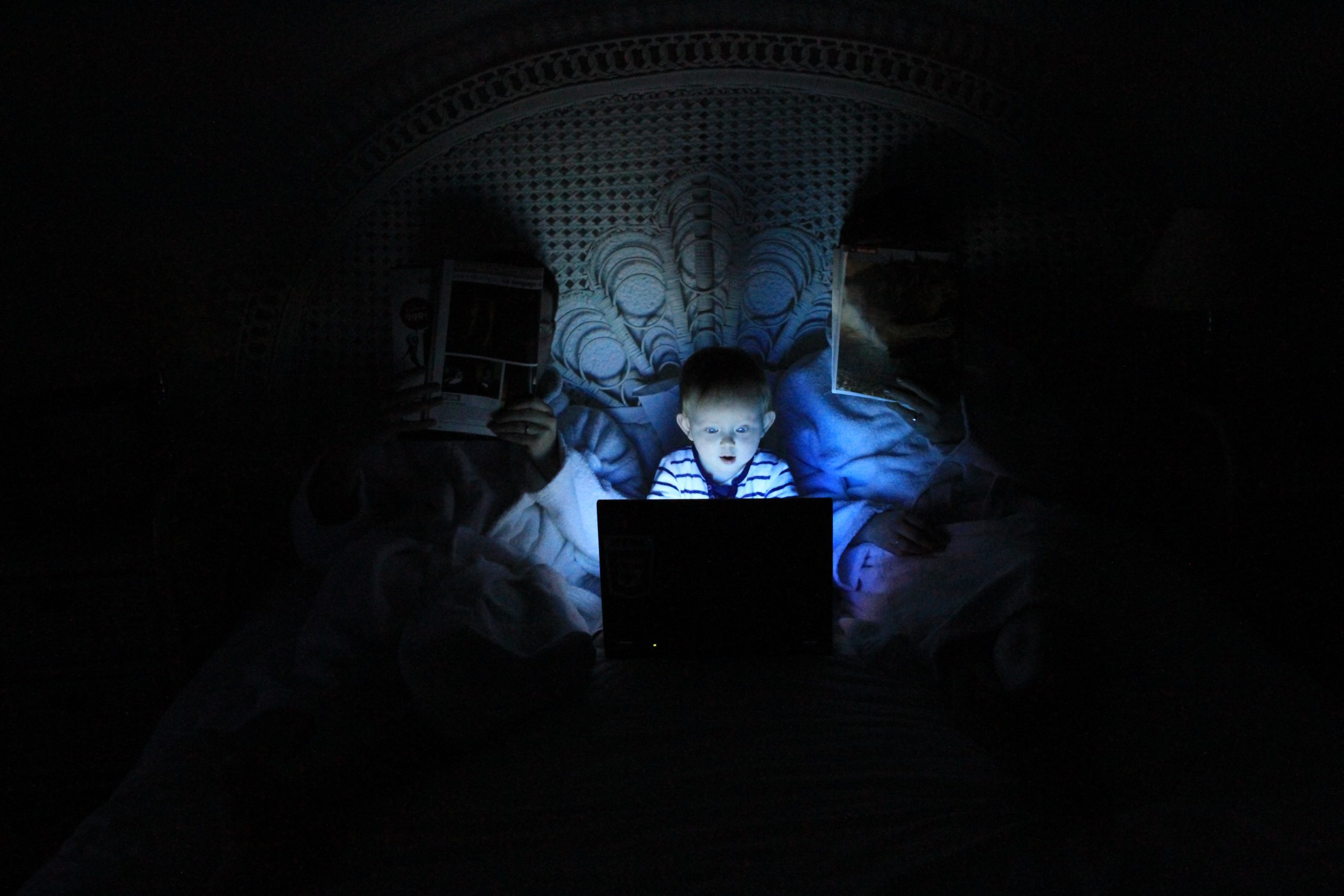 teen watching laptop screen late at night